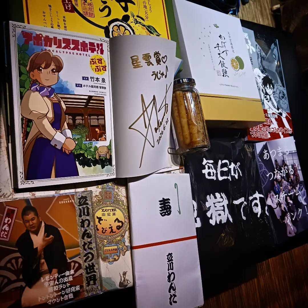 店長の大分SF大会土産ありかぼすチーズ饅頭、ざびえる、柚子こしょうせんべい……目玉は何と言っても星雲賞受賞 竹本泉サイン入り「アポカリプスホテルぷすぷす」!! スチームパンク同人誌、聖悠紀版「宇宙戦艦ヤマト」、立川わんだCDも🥰本日も皆様のお越しをお待ちしております#オタクバー #第64回日本SF大会Hellcon #星雲賞 #アポカリプスホテルぷすぷす #竹本泉